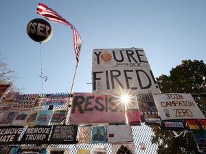 Signs critical of President Donald Trump hang on the security fence that surrounds the White House November 08, 2020 in Washington, DC. More than 75 million ballots were cast for U.S. President-elect Joe Biden and his running mate Vice President-elect Kamala Harris, who defeated Trump in his bid to be re-elected. Chip Somodevilla/Getty Images/AFP