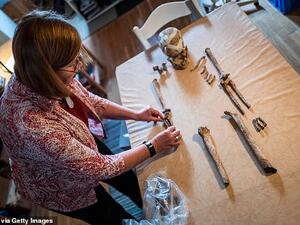 The skeleton had been buried in a settlement in a squatting position, one of the oldest known forms of burial, according to local media. Pictured, Bettina Jungklaus with the remains. (AFP)