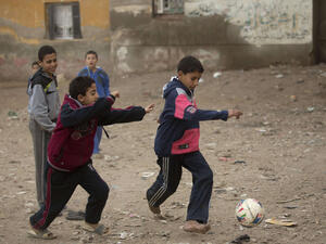 A 2017 file photo shows children playing soccer on an unpaved street in a village near Qalubiyah, north of Cairo, Egypt. (AFP)