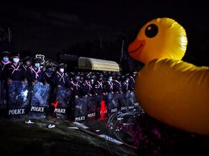 A large inflatable duck is displayed facing riot police as pro-democracy protesters take part in an anti-government rally outside the 11th Infantry Regiment in Bangkok on November 29, 2020. Lillian SUWANRUMPHA / AFP