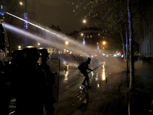 French anti-riot policemen use a watercannon against protesters during a demonstration for 'social rights' and against the 'global security' draft law, which Article 24 would criminalise the publication of images of on-duty police officers with the intent of harming their 'physical or psychological integrity', in Paris, on December 5, 2020. GEOFFROY VAN DER HASSELT / AFP
