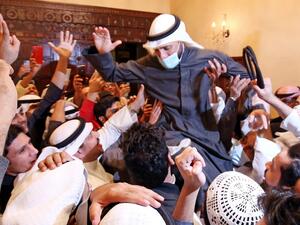 Kuwaiti candidate and Parliament Speaker Marzouq al-Ghanem celebrates with his supporters following the announcement of his victory in parliamentary election in Kuwait city, on December 6, 2020. Unlike other oil-rich Gulf states, Kuwait has a lively political life and its parliament, elected for four-year terms, enjoys wide legislative powers. Political disputes are often fought in public. But with more than 144,000 novel coronavirus cases to date, including 889 deaths, the election campaign has been toned 