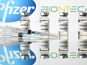 This file illustration photo taken on November 17, 2020 shows vials with Covid-19 Vaccine stickers attached and syringes with the logo of US pharmaceutical company Pfizer and German partner BioNTech. The US Food and Drug Adminstration on December 11, 2020 granted the Pfizer-BioNTech Covid-19 vaccine an emergency use authorization, paving the way for its imminent rollout across the country. JUSTIN TALLIS / AFP
