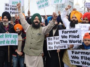 Protesters hold placards and shout slogans against Indian Prime Minister Narendra Modi during a protest rally in support of farmers against the recent agricultural reforms, in Amritsar on December 13, 2020. Narinder NANU / AFP
