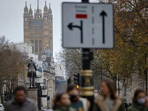Pedestrians walk away from the Palace of Westminster in central London on December 13, 2020, as the leaders of Britain and the European Union agree to contine talks beyond the latest deadline. Sunday is just the latest in a string of supposedly hard deadlines for the negotiations but, with Britain due to leave the EU single market in 19 days, tensions are rising. Tolga Akmen / AFP