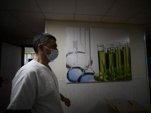 A medical worker wearing a face mask walks across the lab department of the Tor Vergata hospital in Rome on December 21, 2020, during the COVID-19 pandemic caused by the novel coronavirus. Filippo MONTEFORTE / AFP