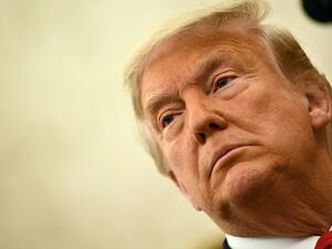 In this file photo taken on December 3, 2020 US President Donald Trump speaks before awarding the Presidential Medal of Freedom to retired football coach Lou Holtz in the Oval Office of the White House in Washington, DC. An angry backlash December 23 met US President Donald Trump's pardons of corrupt Republican congressmen and security guards convicted of killing 14 civilians in a 2007 Baghdad massacre. Trump is believed to be weighing other pardons including members of his family, his personal lawyer Rudy 