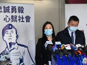 Hong Kong's acting chief superintendent of the Commercial Crime Bureau, Cheng Lai Ki (L), speaks to the media in Hong Kong on December 30, 2020, after the release of the two youngest members of the so-called "Hong Kong 12" held over the border in the southern Chinese city of Shenzhen since last August when the 12 were caught trying to flee the territory for Taiwan. Peter PARKS / AFP