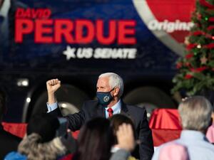Vice President Mike Pence holds a fist up to the crowd during a rally in support of Sen. David Purdue (R-GA) and Sen. Kelly Loeffler (R-GA) on December 10, 2020 in Augusta, Georgia. The "Defend the Majority" rally comes ahead of a January 5th runoff election for Purdue who is facing Democratic candidate Jon Ossoff. Loeffler was unable to attend the event. Jessica McGowan/Getty Images/AFP Jessica McGowan / GETTY IMAGES NORTH AMERICA / Getty Images via AFP