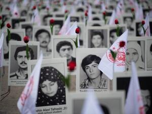 Portraits of victims killed in Iran's massacres of dissidents in 1988 on display at a memorial in France last year. (AFP/File)
