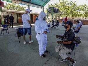 A health worker interviews a Venezuelan man in Cucuta, on the Colombian border with Venezuela, as he waits to get a Covid-19 test at a testing center, on December 28, 2020. Colombia has been one of the worst hit countries in Latin America by the pandemic with more than 1.5 million cases and over 40,000 deaths. Schneyder MENDOZA / AFP A health worker interviews a Venezuelan man in Cucuta, on the Colombian border with Venezuela, as he waits to get a Covid-19 test at a testing center, on December 28, 2020. Colombia has been one of the worst hit countries in Latin America by the pandemic with more than 1.5 million cases and over 40,000 deaths. Schneyder MENDOZA / AFP