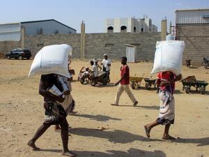 Displaced Yemenis receive humanitarian aid provided by the World Food Programme (WFP) in the northern province of Hajjah, on January 12, 2021. ESSA AHMED / AFP