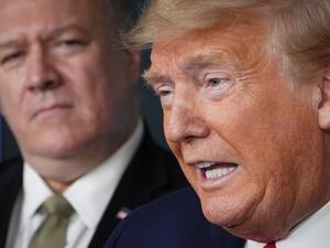 In this file photo US Secretary of States Mike Pompeo listens as US President Donald Trump speaks during the daily briefing on the novel coronavirus, Covid-19, in the Brady Briefing Room at the White House on April 8, 2020, in Washington, DC. Donald Trump in his final days in the White House has seen cabinet members quit, his vice president for the first time take a distance and some members of his party support impeachment. But he still has loyalty until the bitter end from Secretary of State Mike Pompeo. 