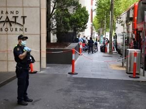 A policeman keeps watch as tennis players, coaches and officials arrive at a hotel in Melbourne on January 15, 2021, before quarantining for two weeks ahead of the Australian Open tennis tournament. William WEST / AFP