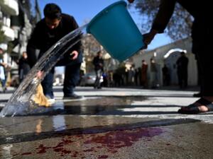 Residents wash a road following gunmen shot dead two Afghan women judges working for the Supreme Court, in Kabul on January 17, 2021. Gunmen shot dead two Afghan women judges working for the Supreme Court during an early morning ambush in the country's capital on January 17, officials said, as a wave of assassinations continues to rattle the nation. WAKIL KOHSAR / AFP