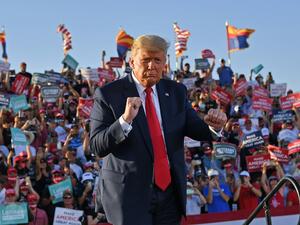 In this file photo taken on October 19, 2020 US President Donald Trump dances as he leaves a rally at Tucson International Airport in Tucson, Arizona. MANDEL NGAN / AFP