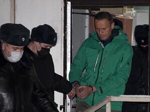 Opposition leader Alexei Navalny is escorted out of a police station in Khimki, outside Moscow, following the court ruling that ordered him jailed for 30 days. Kremlin critic Alexei Navalny on Monday urged Russians to stage mass anti-government protests during a court hearing after his arrest on arrival in Moscow from Germany. Alexander NEMENOV / AFP