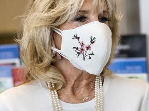 First lady Jill Biden’s necklace spells "Mama" as she takes a tour of Whitman-Walker Health hospital on January 22, 2021 in Washington, DC.  Jacquelyn Martin / POOL / AFP