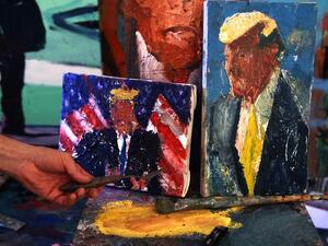 Israeli painter Iddo Markus displays some of his paintings of former US president Donald Trump, at his studio in the northern port city of Haifa, on January 22, 2021. Markus became fascinated by the "tragic figure" of Donald Trump, and the walls and floor of his studio are packed with some 120 portraits of the former US president. Emmanuel DUNAND / AFP