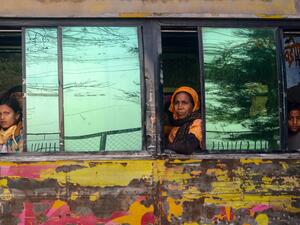 Rohingya refugees look out from a bus headed to a Bangladeshi navy ship in Chittagong on January 30, 2021, that will take them to be relocated to Bhashan Char island in the Bay of Bengal. Munir UZ ZAMAN / AFP