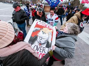 A pair of counter-protesters are confronted by pro-Trump protesters in front of Capitol Building on January 6, 2021 in Washington, DC. A pro-Trump mob stormed the Capitol, breaking windows and clashing with police officers. Trump supporters gathered in the nation's capital today to protest the ratification of President-elect Joe Biden's Electoral College victory over President Trump in the 2020 election. Jon Cherry/Getty Images/AFP