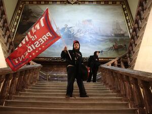  A protester holds a Trump flag inside the US Capitol Building near the Senate Chamber on January 06, 2021 in Washington, DC. Congress held a joint session today to ratify President-elect Joe Biden's 306-232 Electoral College win over President Donald Trump. A group of Republican senators said they would reject the Electoral College votes of several states unless Congress appointed a commission to audit the election results. Win McNamee/Getty Images/AFP WIN MCNAMEE / GETTY IMAGES NORTH AMERICA / Getty Image