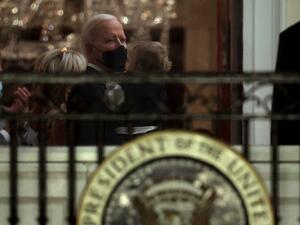 U.S. President Joe Biden holds his grandson Beau Biden before watching a fireworks show on the National Mall from the Truman Balcony at the White House January 20, 2021 in Washington, DC. Biden became the 46th president of the United States earlier today during the ceremony at the U.S. Capitol. Chip Somodevilla/Getty Images/AFP