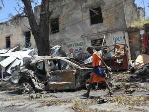 A boy walks past the site of a car bomb attack near a security checkpoint in the Somali capital, not far from the presidential palace in Mogadishu. (File/AFP)