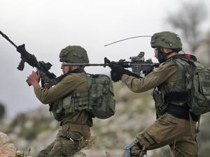 Israeli soldiers hold up their rifles towards Palestinian protesters in the village of Kfar Qaddum, near Nablus in the occupied West Bank (AFP File Photo) Israeli soldiers hold up their rifles towards Palestinian protesters in the village of Kfar Qaddum, near Nablus in the occupied West Bank (AFP File Photo)