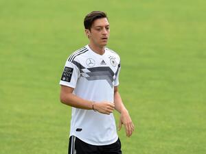 The midfielder confirmed he won't be going back on his decision to retire from international football after being unveiled at Fenerbahce (Photo: AFP)