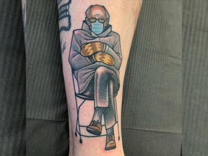 The tattoo shows the 79-year-old senator sitting on a chair with his arms folded over, while wearing thick mittens and socially distancing himself from others. (Instagram)