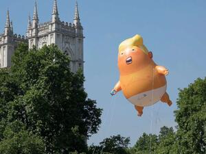 A giant inflatable balloon depicting President Trump as a baby in a nappy is flown over Parliament Square in London, July 13, 2018. (Shutterstock)