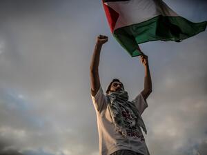 A man waves a Palestinian flag during a protest to mark Nakba Day (AFP) A man waves a Palestinian flag during a protest to mark Nakba Day (AFP)