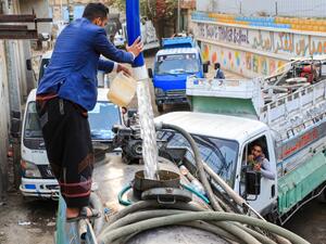 A man fills up a water tanker truck from a tap in Yemen's Huthi rebel-held capital Sanaa on January 23, 2021. Mohammed HUWAIS / AFP