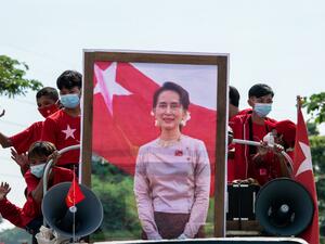 This file photo taken on October 25, 2020 shows supporters of the National League for Democracy (NLD) party taking part in an election campaign event with a portrait of Myanmar State Counsellor Aung San Suu Kyi in Yangon. Myanmar's ousted National League for Democracy party called for the release of Aung San Suu Kyi and other detained leaders on February 2, 2021, describing the coup a day earlier as a "stain" on the military's history. Sai Aung Main / AFP