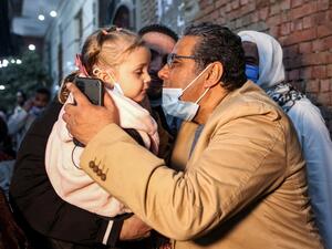 Mahmoud Hussein (R), an Egyptian national and senior journalist for Qatar-based Al Jazeera Arabic, kisses a child upon his arrival at his family home in the Giza village of Zawyet Abu Musallam, about 30 kilometres south of Egypt's capital Cairo on February 6, 2021 upon his release from detention. Egypt has freed the journalist for Qatar's Al Jazeera after four years in jail without trial following the end last month of a rift between the two Arab states. Mahmoud Hussein, an Egyptian national who had been imprisoned since December 23, 2016, was released on Thursday night, the Egyptian security source told AFP without elaborating. Mahmoud Hussein (R), an Egyptian national and senior journalist for Qatar-based Al Jazeera Arabic, kisses a child upon his arrival at his family home in the Giza village of Zawyet Abu Musallam, about 30 kilometres south of Egypt's capital Cairo on February 6, 2021 upon his release from detention. Egypt has freed the journalist for Qatar's Al Jazeera after four years in jail without trial following the end last month of a rift between the two Arab states. Mahmoud Hussein, an Egyptian national who had been im