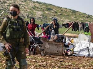 Bedouin women and children remain by their tents and structures after Israeli forces demolished them in the Humsa area east of the Palestinian village of Tubas, in the occupied West Bank, on February 8, 2021. JAAFAR ASHTIYEH / AFP