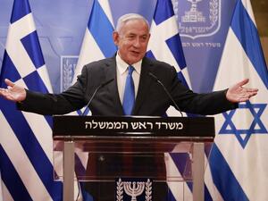 Israeli Prime Minister Benjamin Netanyahu delivers a statement next to the Greek Prime Minister Kyriakos Mitsotakis (unseen) after their meeting in the Prime Minister's office in Jerusalem on February 8, 2021. menahem kahana / POOL / AFP