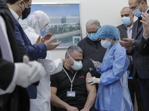 Head of the intensive care unit at Lebanon's Rafik Hariri Hospital battling the coronavirus, Mahmoud Hassoun, receives the first jab of the COVID-19 Pfizer/BioNTech vaccine at the hospital premises as the country kickstarts its inoculation campaign, in the capital Beirut, on February 14, 2021. Lebanon gave its first COVID-19 vaccine dose to a doctor, as it started inoculation it hopes will keep the pandemic in check amid a deepening economic crisis. ANWAR AMRO / AFP