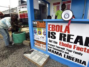 In this file photograph taken on September 30, 2014, Liberians wash their hands next to an Ebola information and sanitation station, raising awareness about the virus in Monrovia. Pascal GUYOT / AFP