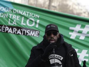 A member of the anti-negrophobia brigade named Issa speaks as protesters demonstrate against a bill dubbed as "anti-separatism", in Paris on February 14, 2021. GEOFFROY VAN DER HASSELT / AFP