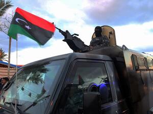 Members of Libyan security forces take part in a military parade on the eve of celebrations marking the 10th anniversary of the revolution in the port city of Tajoura, on February 16, 2021. Libyans mark on February 17 the tenth anniversary of the start of a revolution that toppled dictator Moamer Kadhafi, a pyrrhic occasion for many, in a country still engulfed in chaos. Mahmud TURKIA / AFP