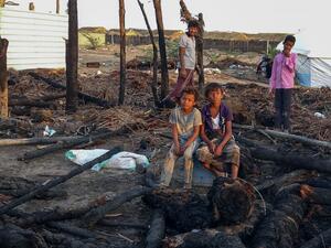 Displaced Yemeni youths sit by of calcined wooden poles after a fire broke out in a shelter in the war-ravaged western Hodeida province, on February 16, 2021. Khaled Ziad / AFP