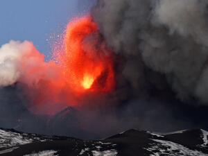 This photo obtained from Italian news agency ANSA shows the Etna volcano in Catania, Sicily, on February 16, 2021 during a spectacular eruption and a strong explosive activity from the south-east crater and the emission of a high cloud of lava ash that disperses towards the south. Handout / ANSA / AFP