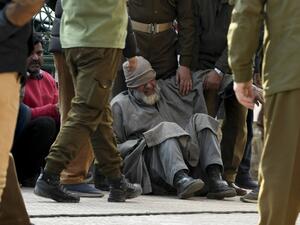 A relative (C) of a slain policeman griefs before a wreath laying ceremony at a police headquarter in Srinagar on February 19, 2021 after unidentified gunmen killed two police personnel in Srinagar. TAUSEEF MUSTAFA / AFP