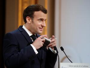 French President Emmanuel Macron removes his protective face mask as he attends the 2021 Munich Security Conference held by video link at the Elysee Palace in Paris on February 19, 2021 amidst the coronavirus disease (Covid-19) outbreak. BENOIT TESSIER / POOL / AFP French President Emmanuel Macron removes his protective face mask as he attends the 2021 Munich Security Conference held by video link at the Elysee Palace in Paris on February 19, 2021 amidst the coronavirus disease (Covid-19) outbreak. BENOIT TESSIER / POOL / AFP
