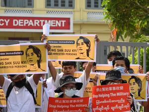 Protesters hold placards and display images of ousted civilian leader Aung San Suu Kyi as they take part in a demonstration against the military coup, in front of the Chinese embassy in Yangon on February 21, 2021. Sai Aung Main / AFP