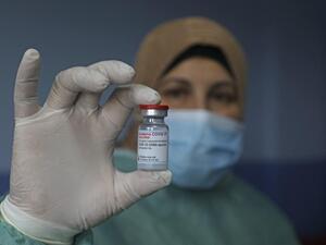 A Palestinian health worker holds vial of Covid-19 vaccine at Palestine Red Crescent hospital in West Bank city of Nablus, on 4 February (AFP/File photo) A Palestinian health worker holds vial of Covid-19 vaccine at Palestine Red Crescent hospital in West Bank city of Nablus, on 4 February (AFP/File photo)