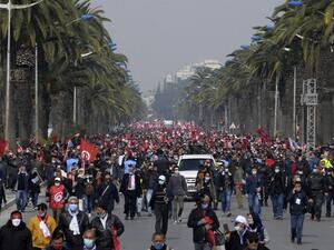 Supporters of the Islamist Ennahdha party wave flags 