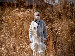Reverend Akira Sato in a protective suit 